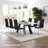 A modern dining room with a white table and black chairs, set on a cream rug. Large windows and a plant add to the ambiance. Náhled obrázku produktu
