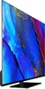 A side view of a large flat-screen television with a colorful abstract image displayed on its screen, resting on a black stand. Produktbild-Vorschau