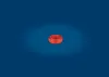A coil of red trimmer line is centered on a dark blue background with a spotlight effect. Produktbild-Vorschau