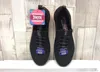A pair of black Skechers sneakers with pink accents, displayed on a light wood-grain background. Náhled obrázku produktu