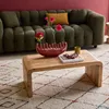 A living room scene with a couch, coffee table, and rug. Produktbild-Vorschau