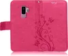A pink flip case for a Samsung Galaxy S9 Plus phone, with a floral and butterfly embossed design. Produktbild-Vorschau