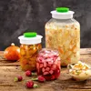 Fermentation jars and vegetables on a wooden table. Náhled obrázku produktu