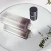 A bottle of toner is shown on a reflective surface with some greenery in the background. Anteprima dell’immagine prodotto