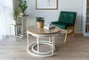 A living room setting with a chair and coffee table. Produktbild-Vorschau
