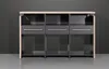 A modern sideboard or cabinet with three drawers and three open shelves, presented against a dark gray wall. Produktbild-Vorschau