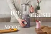 A person is using a stand mixer to make a smoothie, with ingredients and a finished drink visible. Voir les images du produit