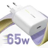 A white OPPO SuperVOOC charger is shown with abstract wavy lines in purple and yellow behind it. The text '65w' is prominently displayed in the foreground. Produktbild-Vorschau