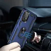 A hand holding a blue phone case with a ring holder, which is magnetically attached to a car vent mount. Produktbild-Vorschau