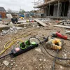 Construction site with tools and extension cord. Produktbild-Vorschau