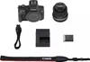 A flat lay of a camera and its accessories. Voir les images du produit
