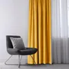 A dark gray chair with a gray pillow sits next to a yellow curtain. Produktbild-Vorschau