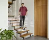 A man is vacuuming the stairs with a cordless vacuum cleaner. Anteprima dell’immagine prodotto