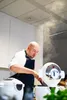A chef is using a multi-functional cooking pot in a kitchen. Podgląd zdjęcia produktu