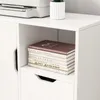 A close-up of a white shelf unit with books stacked on it. Podgląd zdjęcia produktu