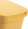 A close-up view of the lid and upper rim of a yellow plastic trash can. Podgląd zdjęcia produktu