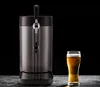 A beer dispenser and a glass of beer against a black background. Voir les images du produit
