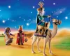 Three figures dressed as the Three Wise Men, one riding a camel, in a desert landscape under a starry night sky. Náhled obrázku produktu