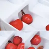 A collage of three close-up shots of red cherries being pitted by a cherry pitter. Produktbild-Vorschau