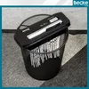 A paper shredder is placed on top of a black mesh waste bin, with shredded paper inside the bin. Náhľad obrázku produktu