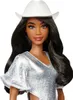 A Barbie doll wearing a glittery cowgirl outfit and a white cowboy hat. Produktbild-Vorschau