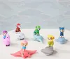 A collection of Paw Patrol Aqua Pups action figures riding on toy sea creatures, arranged on a white surface against a light blue wavy background. Produktbild-Vorschau