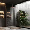 A modern bathroom with a glass shower enclosure, plants, and stone walls. Náhled obrázku produktu