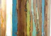 A close-up view of a wooden shelf with distressed paint in various colors. Produktbild-Vorschau