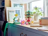 A collection of Lego models and decorative items displayed on a shelf in front of a window. Anteprima dell’immagine prodotto