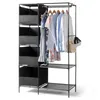 A black metal framed closet with fabric storage cubes and hanging clothes on a clothes rack. Produktbild-Vorschau