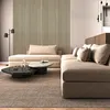 A modern living room with a sectional sofa, coffee table, and decorative wall panels. Produktbild-Vorschau