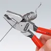 A close-up shot of a pair of pliers with red handles, gripping a piece of wire that is coiled into a spring. Voir les images du produit
