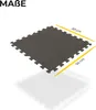 A single dark gray interlocking floor mat is shown from a slightly elevated angle on a white background, with yellow lines indicating dimensions. Náhľad obrázku produktu
