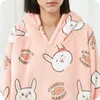 Close-up of a person wearing a pink hoodie blanket with a rabbit and carrot pattern. Náhled obrázku produktu