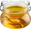 A close-up shot of a glass jar filled with honey, with other empty jars in the background. Náhľad obrázku produktu