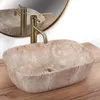 A close-up shot of a beige oval vessel sink with a gold faucet, placed on a wooden surface. Anteprima dell’immagine prodotto