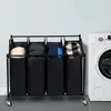 A laundry sorter with four compartments next to a washing machine. Voir les images du produit