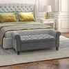A bedroom scene with a bed, pillows, a bench, and a nightstand with a lamp. Produktbild-Vorschau