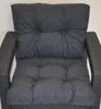 A close-up view of dark gray cushions on a rattan chair. Produktbild-Vorschau
