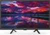 A television displaying a scenic landscape with mountains and a lake. Voir les images du produit