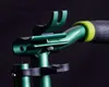 A close-up shot of a green scooter part with a black handle and a yellow ring. Náhľad obrázku produktu