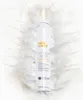 A white bottle of Milk_Shake Whipped Cream leave-in foam is surrounded by splashes of white liquid, resembling milk or cream. Anteprima dell’immagine prodotto