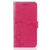 A pink flip case for a smartphone with a floral embossed pattern. Produktbild-Vorschau