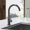 A close-up view of a modern kitchen faucet and sink. Produktbild-Vorschau