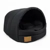A black dog bed with a hood, shown from a slightly elevated side angle on a white background. Podgląd zdjęcia produktu