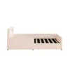 A side view of a beige upholstered bed frame with a slatted mattress base. Produktbild-Vorschau