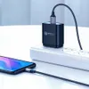 A smartphone charger and cable plugged into a power strip, with a smartphone connected to the cable. Produktbild-Vorschau