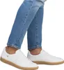 A person wearing jeans and white sneakers. Produktbild-Vorschau