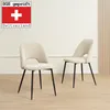 Two beige chairs with black legs are shown in a room with a light-colored wall and wooden floor. Náhled obrázku produktu