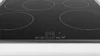 A close-up, eye-level, angled view of a black induction cooktop with four burners, showing the control panel. Voir les images du produit